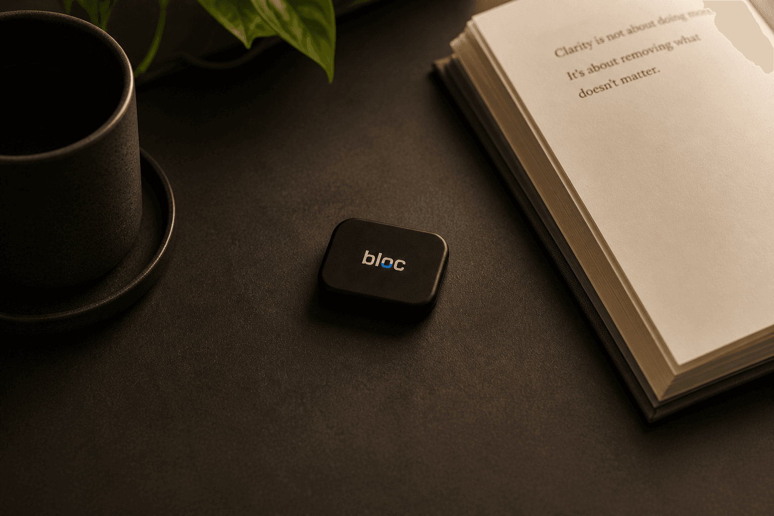 bloc next to an open book and a cup of coffee
