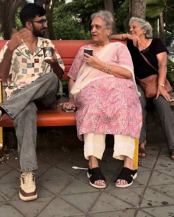 On a bench on Carter Road, talking to two older women, one holding her phone
