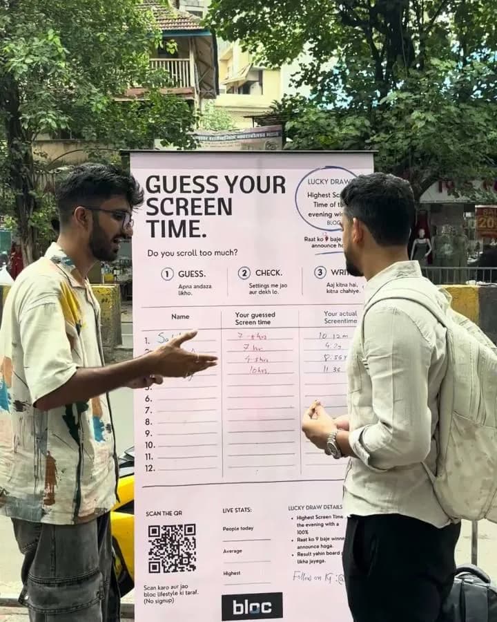 A young man with a backpack at the board by a Dadar roadside